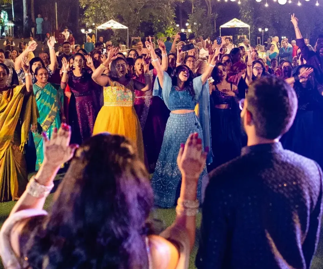 The best parties are when everyone, from your college friends to your grandparents, is on the dance floor. This shot from a beautiful lakeside sangeet in Bangalore captures the pure, uninhibited joy we aim to create, where the energy of the crowd is absolutely electric.