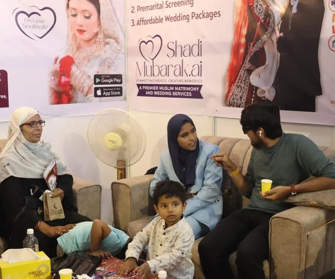 Here I am at a business expo, personally consulting with a family. The banner behind us highlights my core services, including Background Verification and Premarital Screening, which are central to ensuring a secure and transparent match for you.
