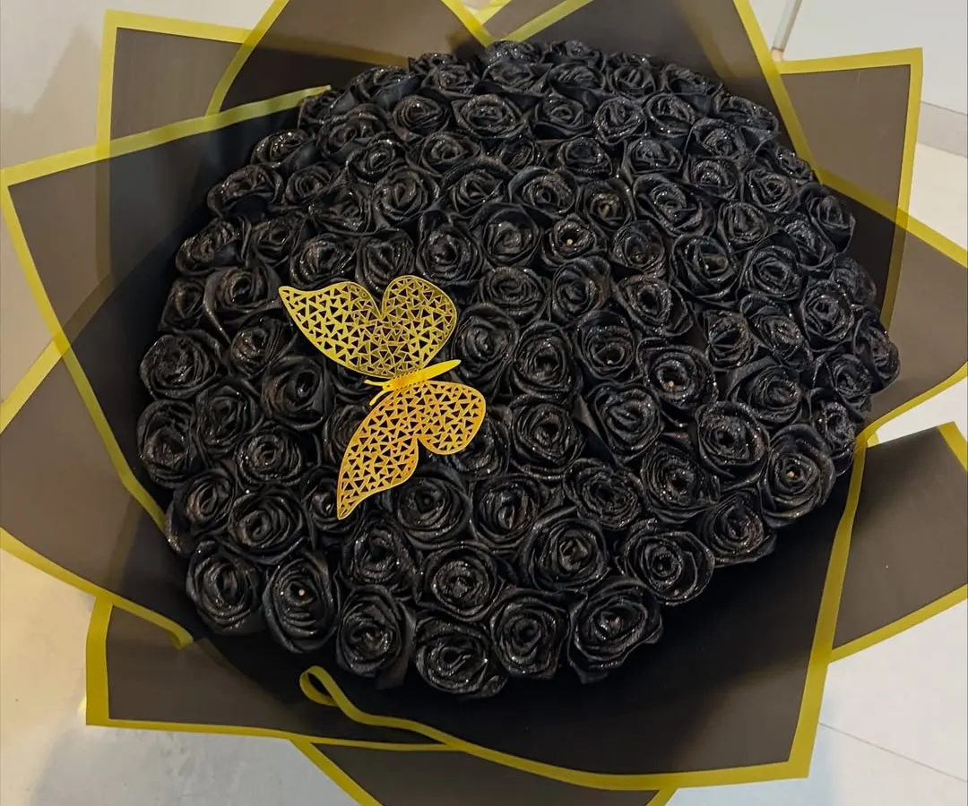 For a love that's bold and timeless, I crafted this bouquet of 100 sparkling black satin roses. These forever flowers make a dramatic statement and last as a keepsake, complete with a delicate golden butterfly accent.
