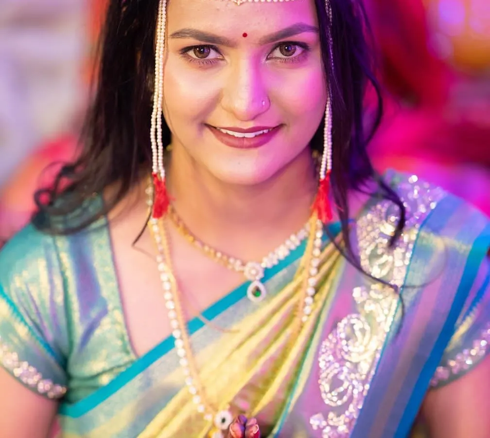 A close-up of the beautiful Marathi bride Ritu, showcasing her flawless engagement look. I enhanced her features with a subtle glow and a defined eye, letting her traditional 'mundavalya' and radiant smile be the focus.