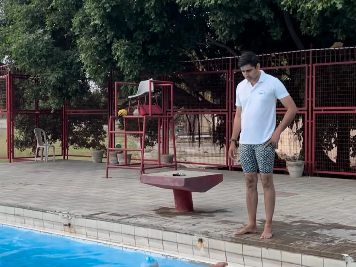 Our certified coaches provide hands on instruction and constant observation. Here, a coach guides swimmers through kickboard drills to build lower body strength and improve kicking technique.