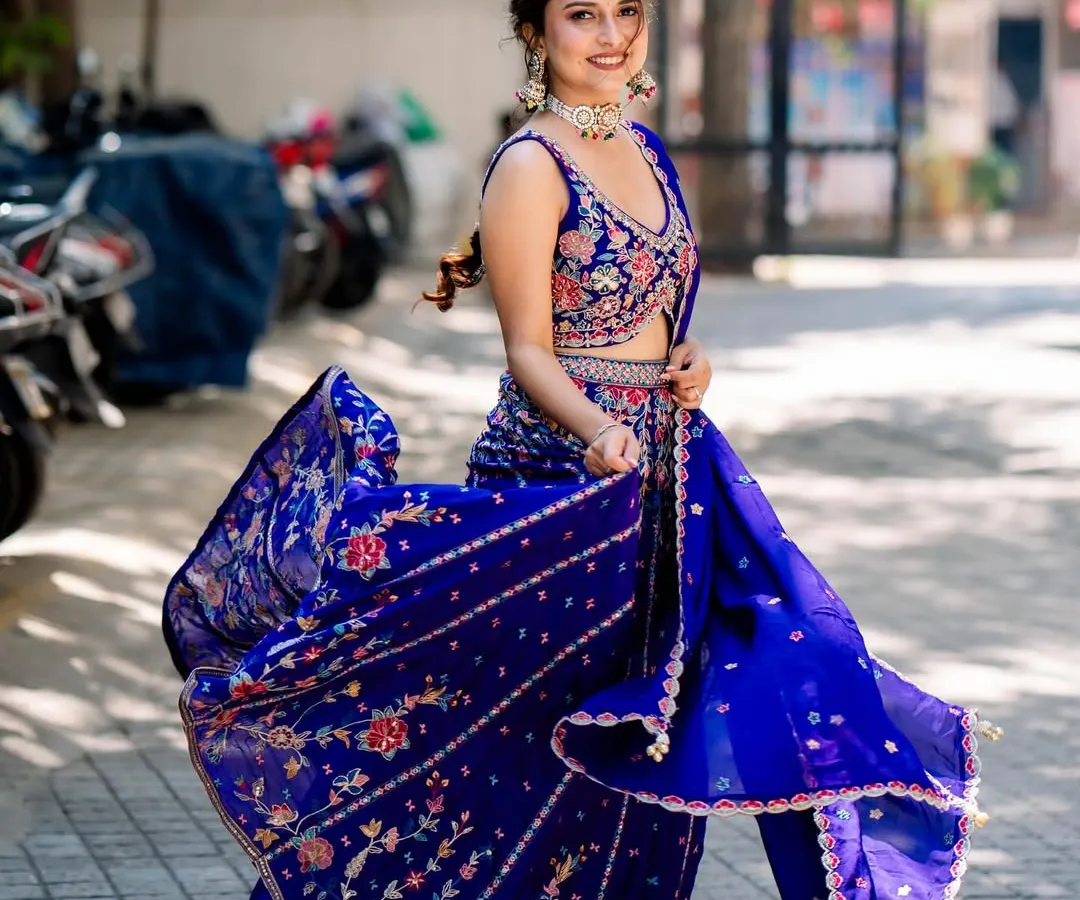 Here’s one of our clients looking absolutely radiant for her mehendi. This royal blue lehenga features intricate floral embroidery, and the way it moves is just magic. It’s the perfect blend of traditional craft and modern energy.