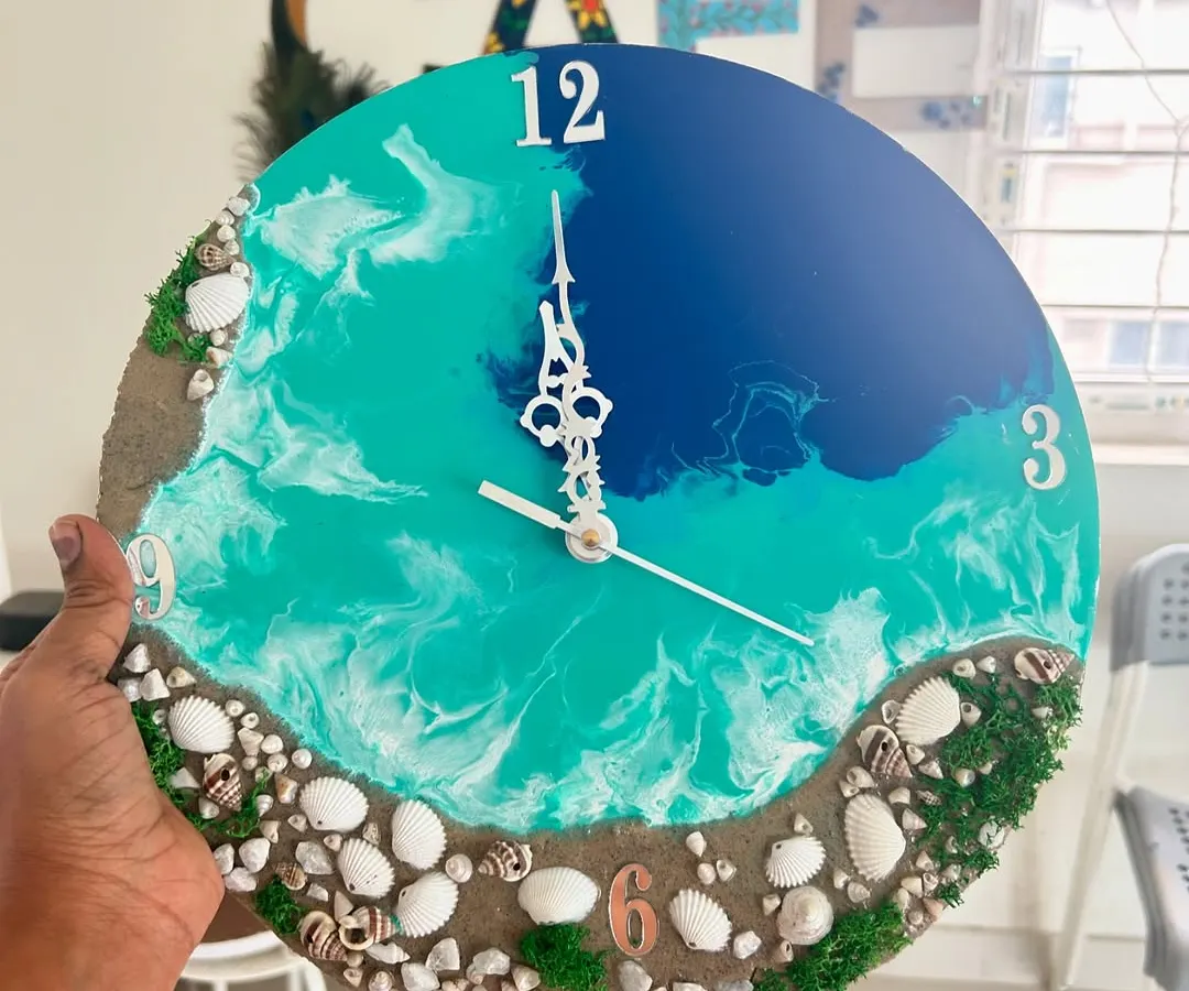 This is one of my favorite custom resin art pieces, a beach-themed wall clock. You can learn to make your own in a workshop or commission a unique piece for your home, complete with real sand and shells.