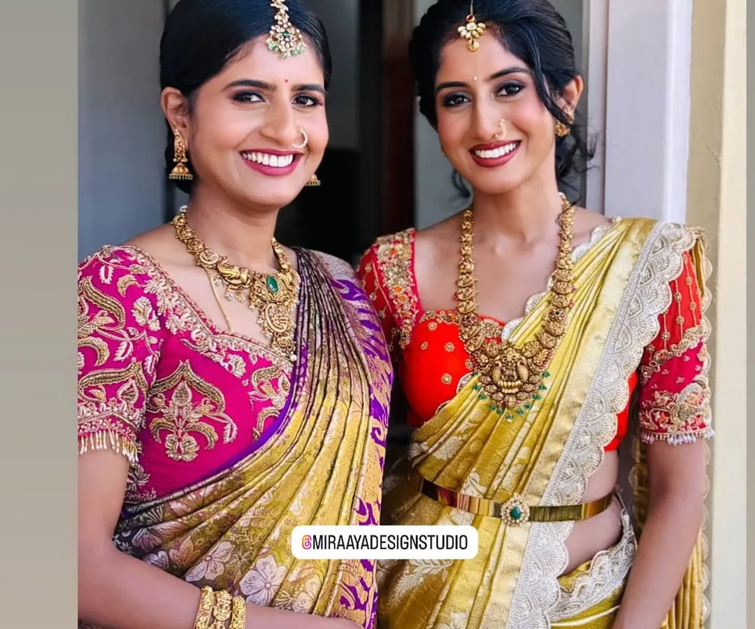 I love creating coordinated looks for family and friends. Here, two clients are ready for a wedding celebration in their custom blouses, one with vibrant pink zardosi work and the other in a bright yellow and red combination, both designed to complement their beautiful silk sarees.