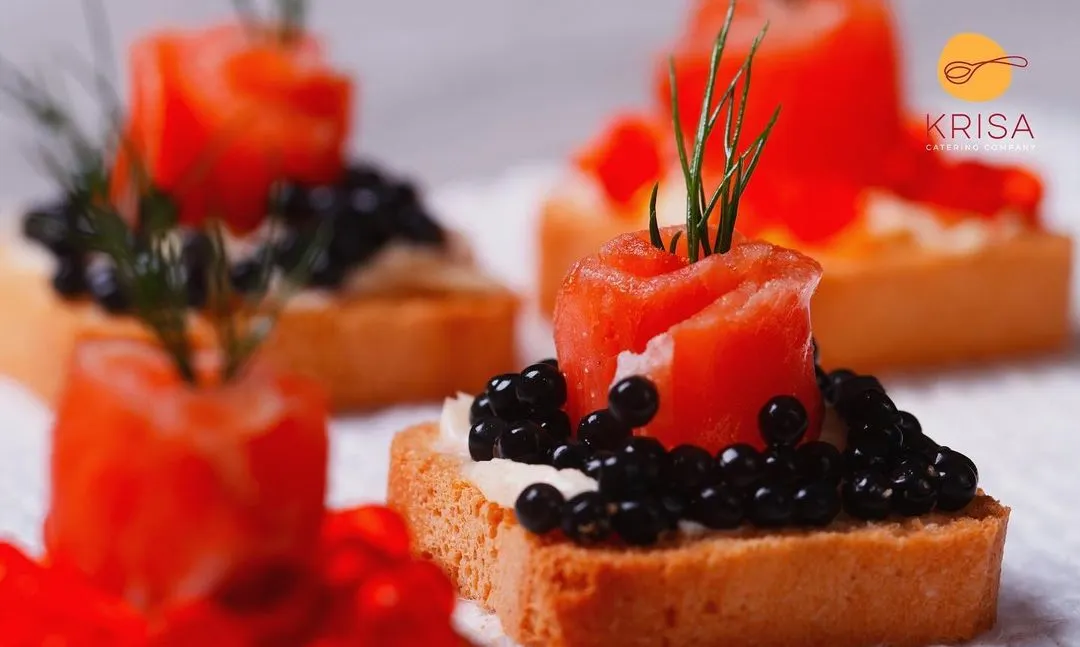 We believe luxury is in the details. This canapé features delicate smoked salmon shaped into a rose, topped with premium black caviar and a sprig of fresh dill on a crisp toast point. It is a perfect example of the elegant, bite-sized appetizers we create for cocktail hours.