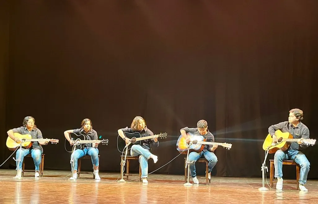 From the practice room to the spotlight. Our guitar students command the stage during our annual 'Sarvaang' showcase, performing a musical medley for a live audience. We ensure every student gets the chance to experience the thrill of a real performance.