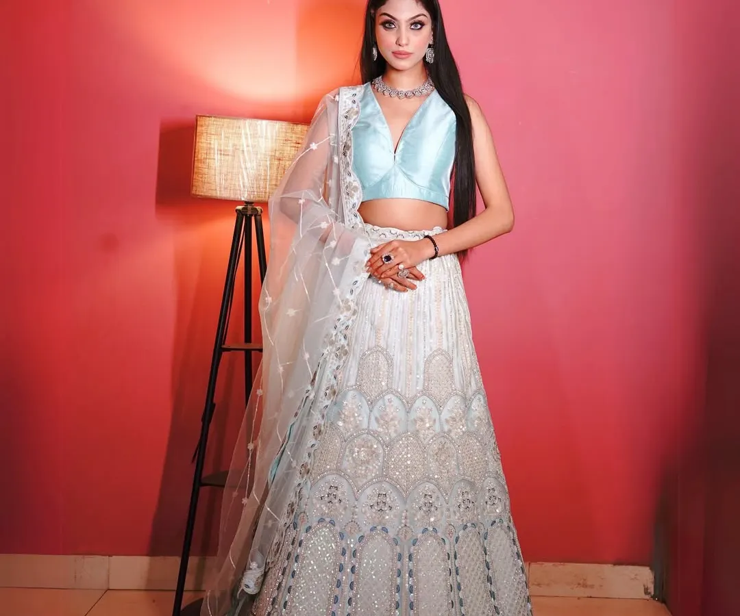 This is one of my favorite pieces, a stunning light blue and silver lehenga. The detailed chikankari style embroidery on the skirt and the simple, elegant blouse make it perfect for a sangeet or a friend's wedding reception.