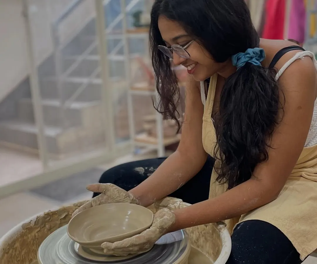 Look at that smile! This is the joy we aim to create in every class. The moment you lift your very first creation off the wheel is truly special, and we love sharing it with you.