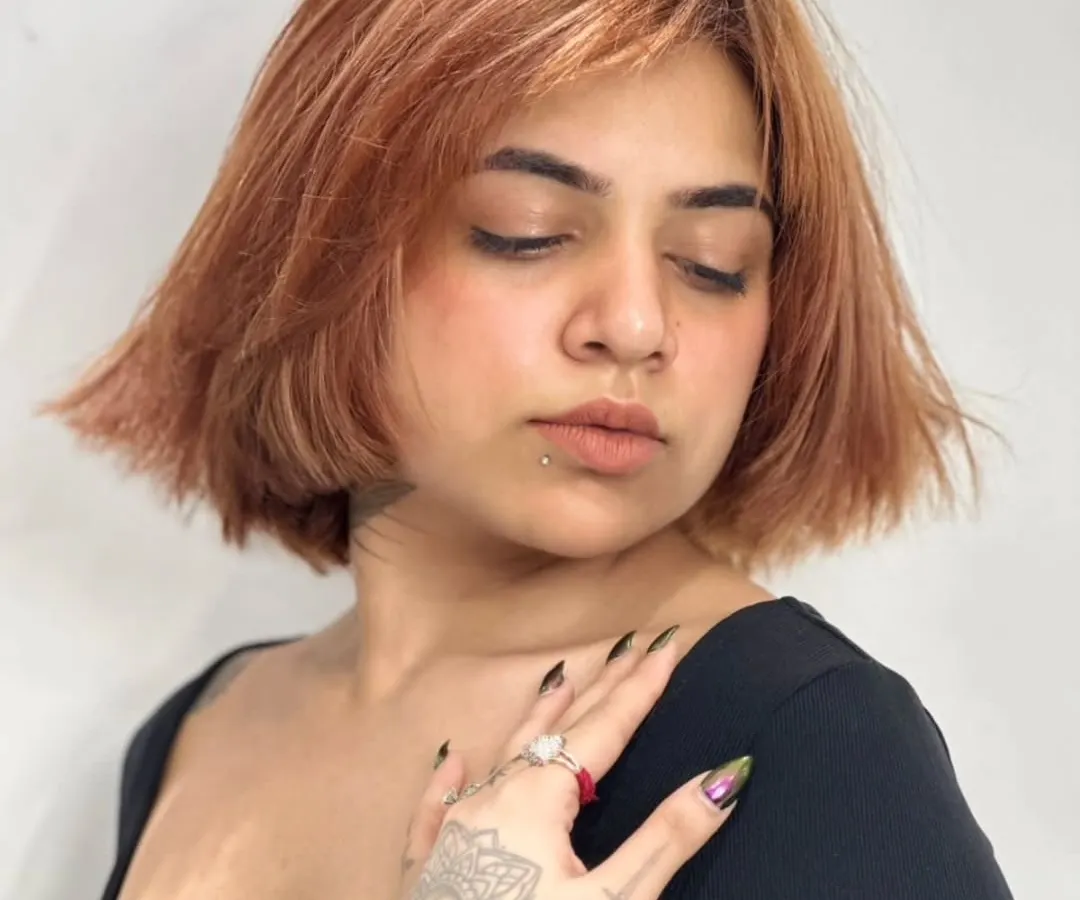 A haircut can be a statement. This edgy copper brown bob with textured bangs is designed to frame the face and sharpen the jawline, delivering a fresh and fearless look.