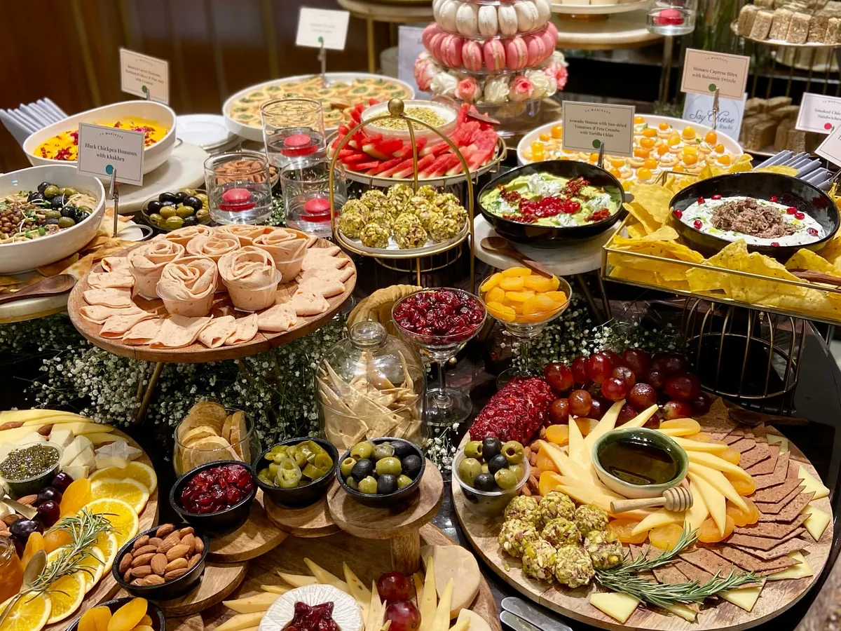A look at one of our spectacular grazing tables, crafted for a luxury brand event. We combine artisanal cheeses, fresh fruits, savory bites like spinach and feta tarts, and sweet treats like macaron towers to create a spread that is as beautiful as it is delicious.
