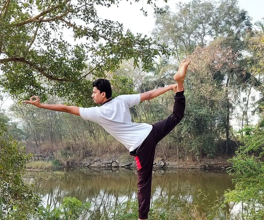 This is Natarajasana, the Lord of the Dance Pose, which embodies the cosmic dance of Lord Shiva. It is a profound expression of dynamic balance and grace. Through this asana, we learn to find stillness even in movement, creating a harmony between strength and flexibility.