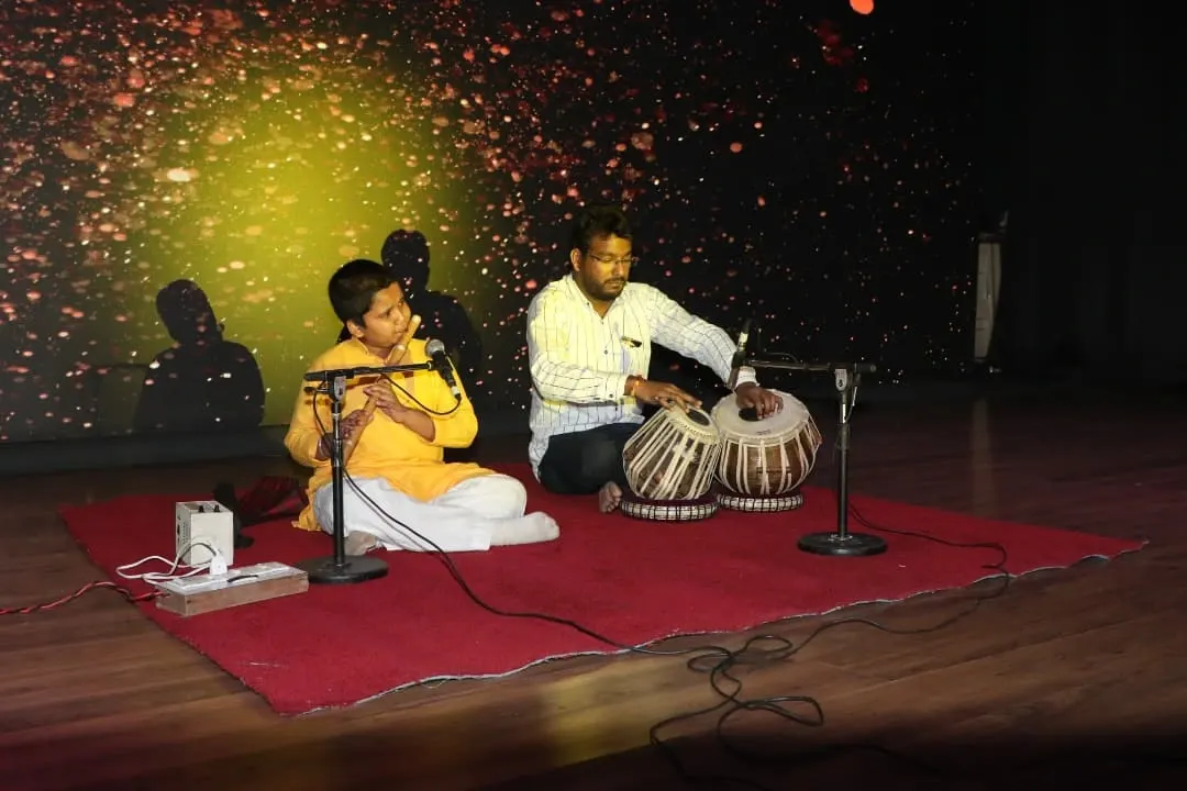A beautiful moment of 'jugalbandi' between a young flutist and his guru on the tabla. This image embodies our commitment to the Guru-Shishya tradition, where classical training is passed on with personal attention and care.