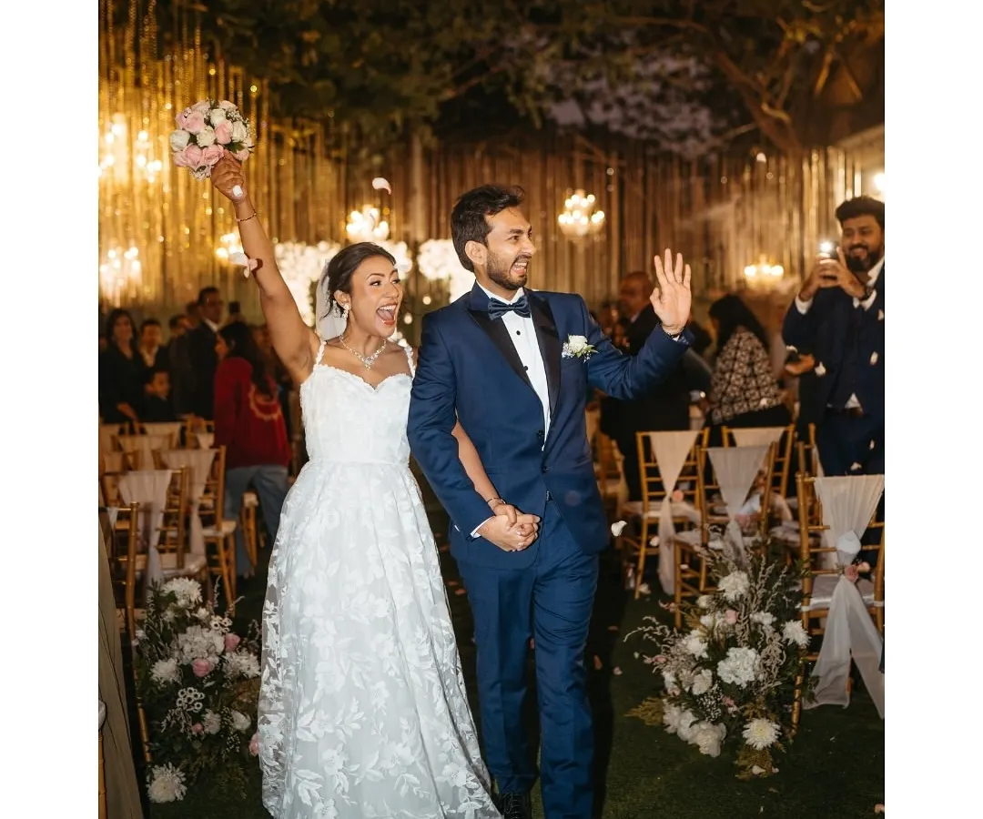 The pure, unfiltered joy of walking out hand-in-hand as husband and wife. We live for these moments of celebration, capturing the energy as you step into your forever, showered with love and flower petals.