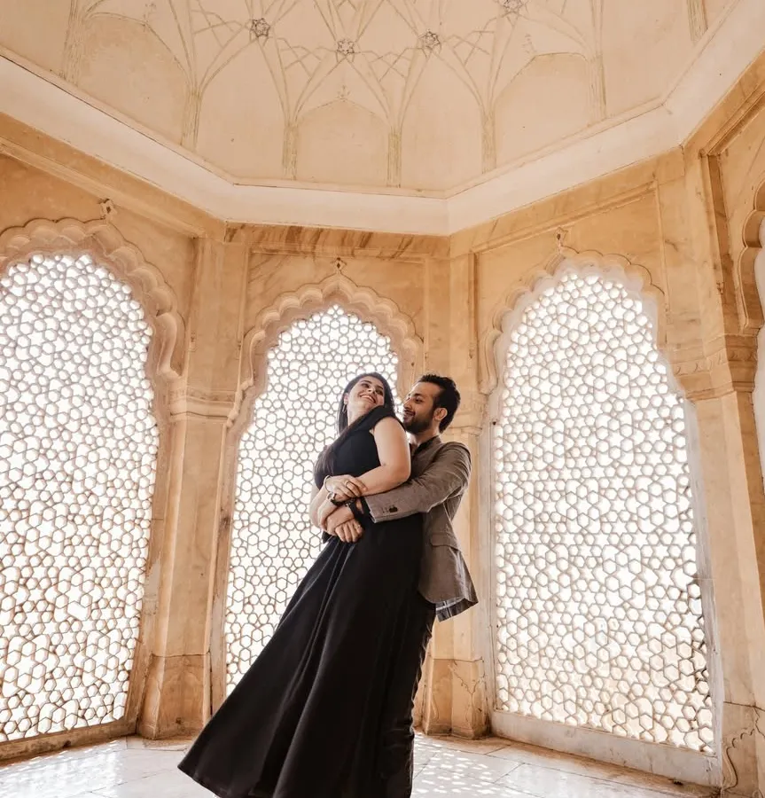 Inside the intricate marble halls of Amer Fort, we captured this moment of pure joy. The way the light filters through the jali windows creates a timeless, fine-art feel, perfect for a couple wanting elegant and romantic portraits.