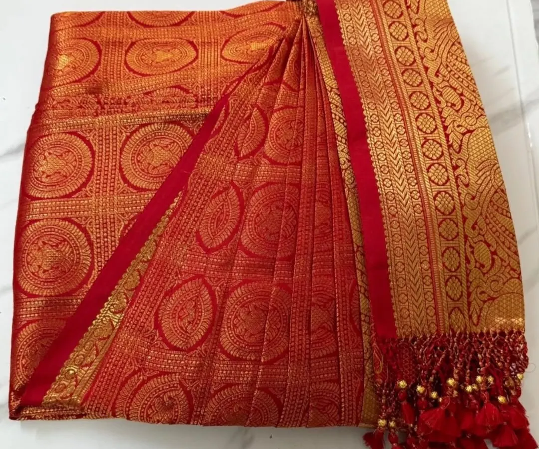 This is where the magic begins. A stunning red and gold bridal Kanjeevaram, with its skirt and pallu pleats crisply pressed and folded. It's boxed and ready for the bride to wear without any last-minute stress.