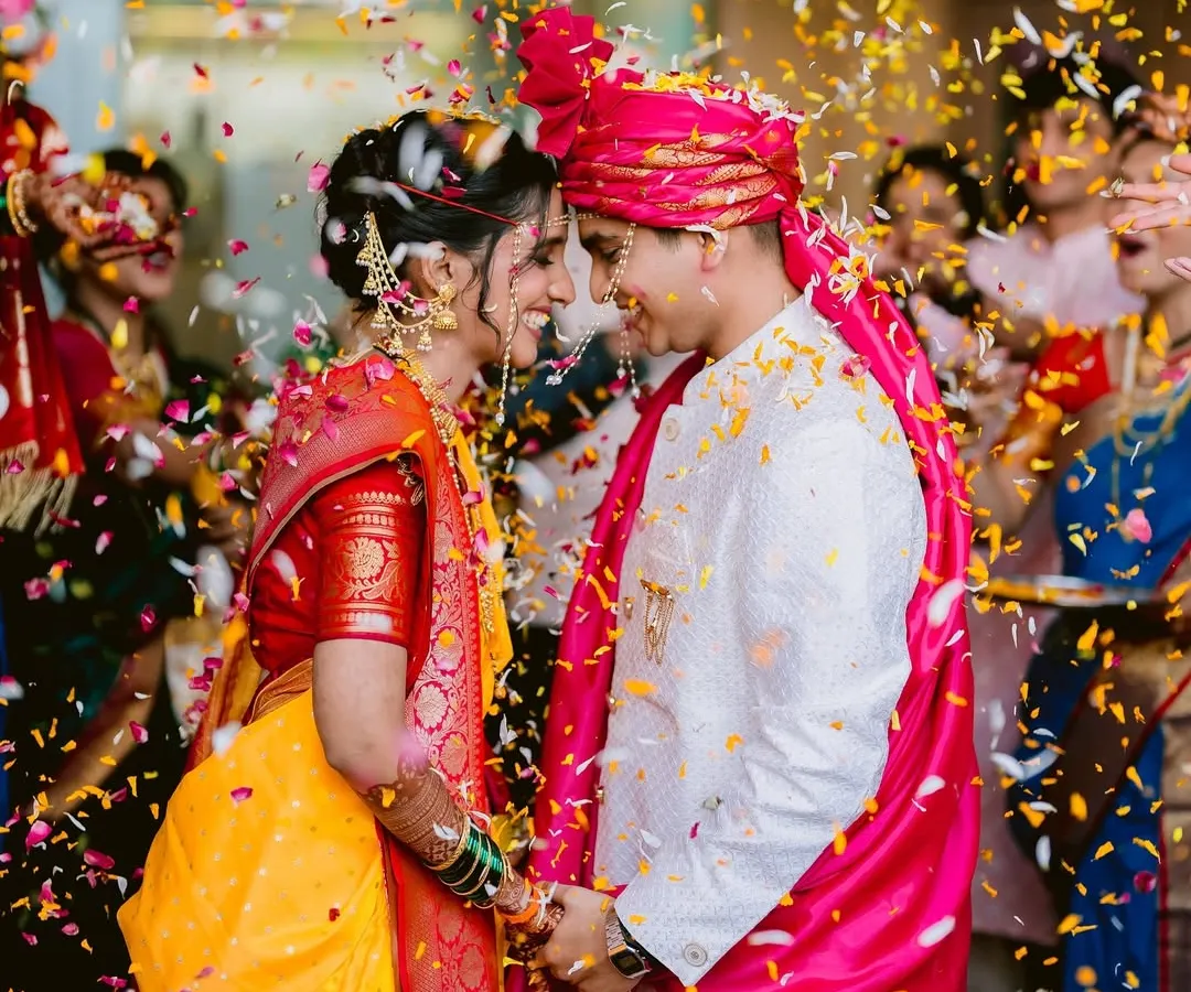 A shower of petals and blessings. This single frame from Ravija and Samarth's Mumbai wedding is bursting with the joy and energy of the Varmala ceremony, a moment of pure celebration.