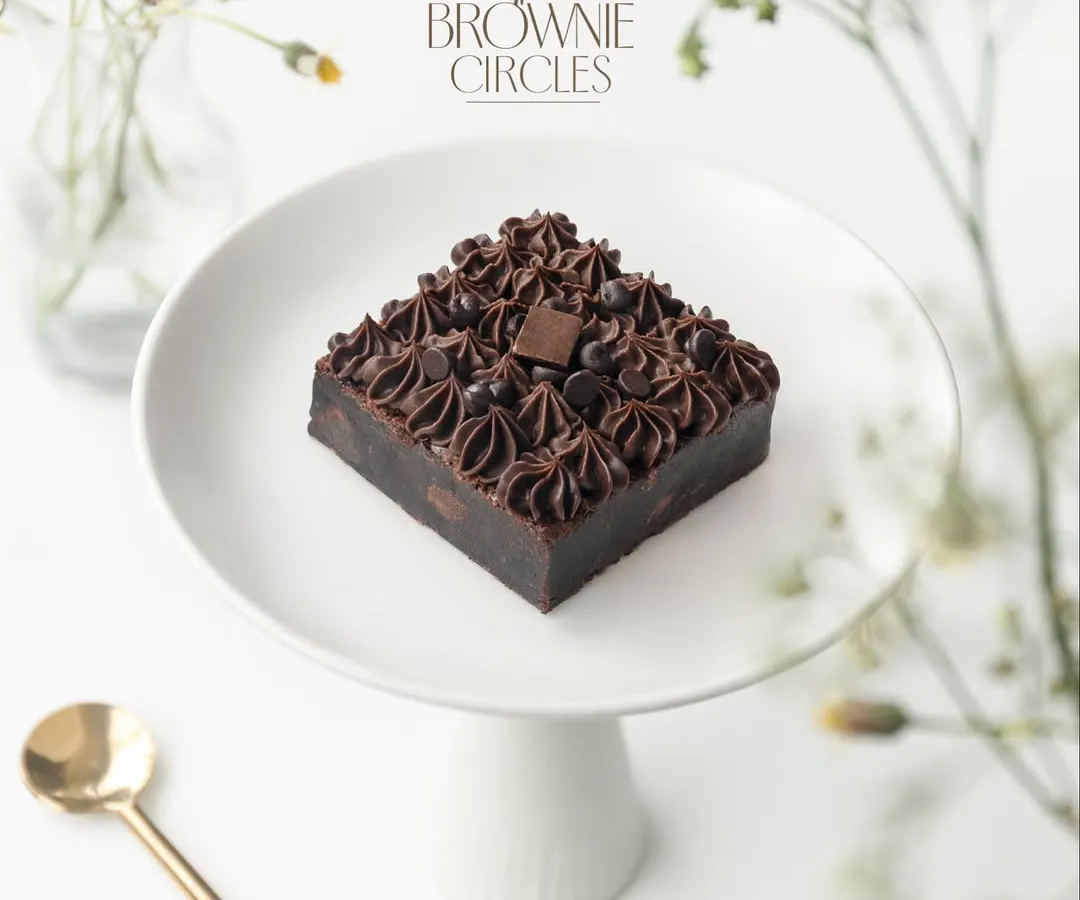 This is our Real Chocolate Overload brownie, and it lives up to its name. Made with pure couverture chocolate and real butter, it's incredibly fudgy and rich. This is the kind of quality that started our entire journey.