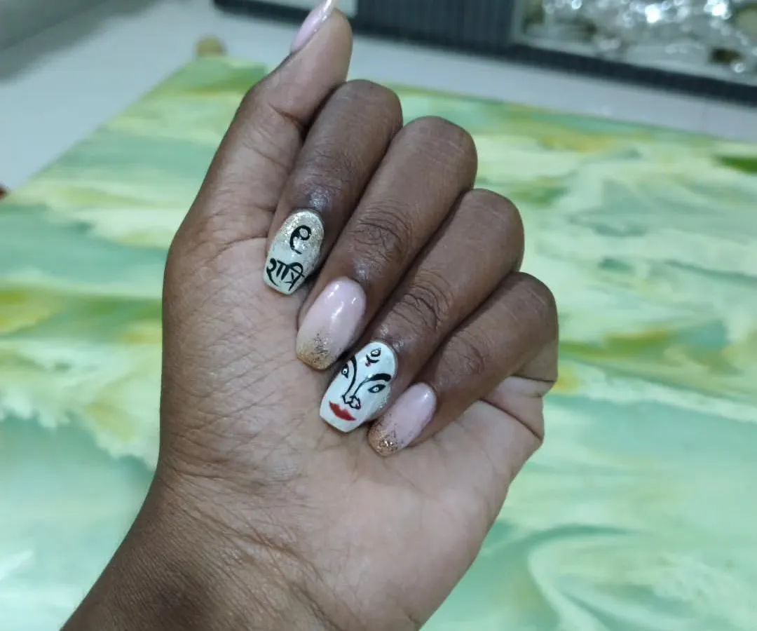 For Navratri, I created this special set featuring a hand-painted Devi Maa face and "Shakti" written in Devanagari script. I love making unique festive nail art that helps you celebrate in style. This design is done with gel polish on natural nails with a touch of gold glitter.