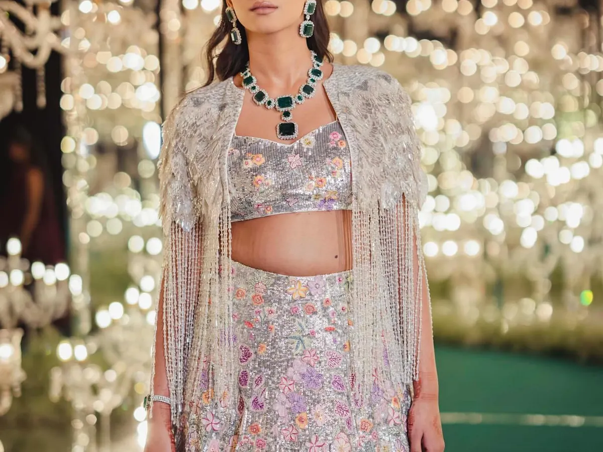 For a bride's sangeet, we wanted a showstopper. This stunning floral lehenga with a beaded cape was a look we spotted on the runway and knew it was the one. It’s all about finding that perfect balance of glamour and personality.