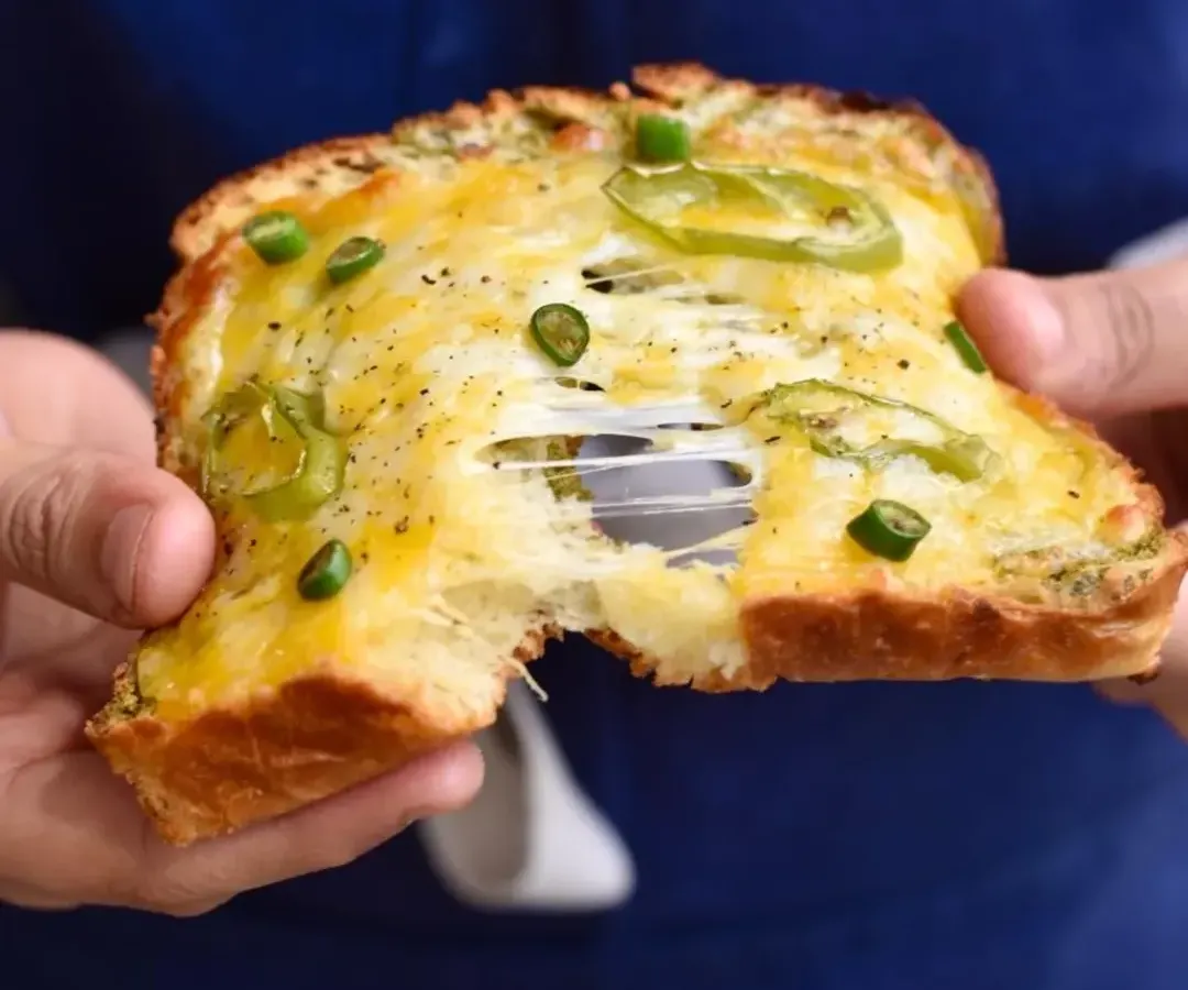 This is our take on a Bombay classic, the Chilli Cheese Toast. We use our fluffy brioche, load it with cheese and green chillies, and bake it until it's golden and gooey. That cheese pull is everything you've dreamed of.