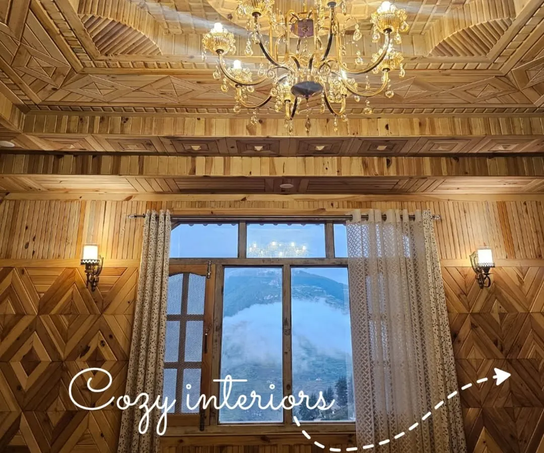 The interiors are designed to feel like a warm embrace, with intricate woodwork done by local artisans. This is a look inside one of the rooms, where you can see the valley right from your window.