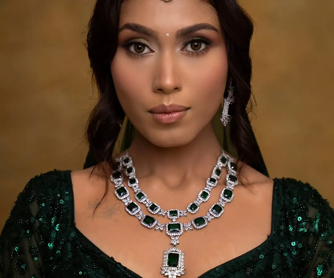 A close-up of a glamorous look perfect for a cocktail party or wedding reception. I used a blend of gold and brown eyeshadows to create a soft glam eye, paired with defined brows and a neutral lip, ensuring the focus remains on the client's radiant skin and stunning emerald jewelry.