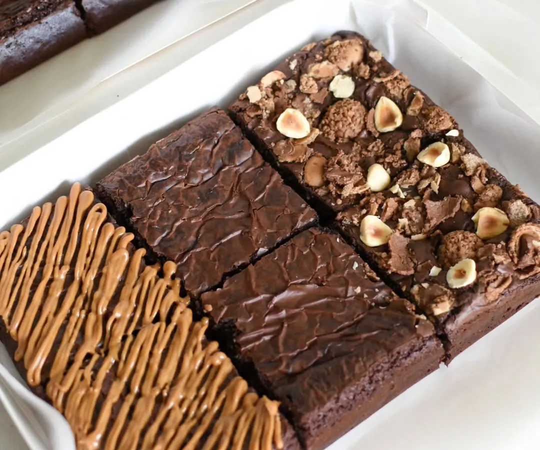 My assorted eggless brownie box is a crowd-pleaser, featuring a trio of my most-loved flavors: rich Double Chocolate Chip, gooey Biscoff, and indulgent Nutella Ferrero Rocher. It's the perfect box for gifting or treating yourself.