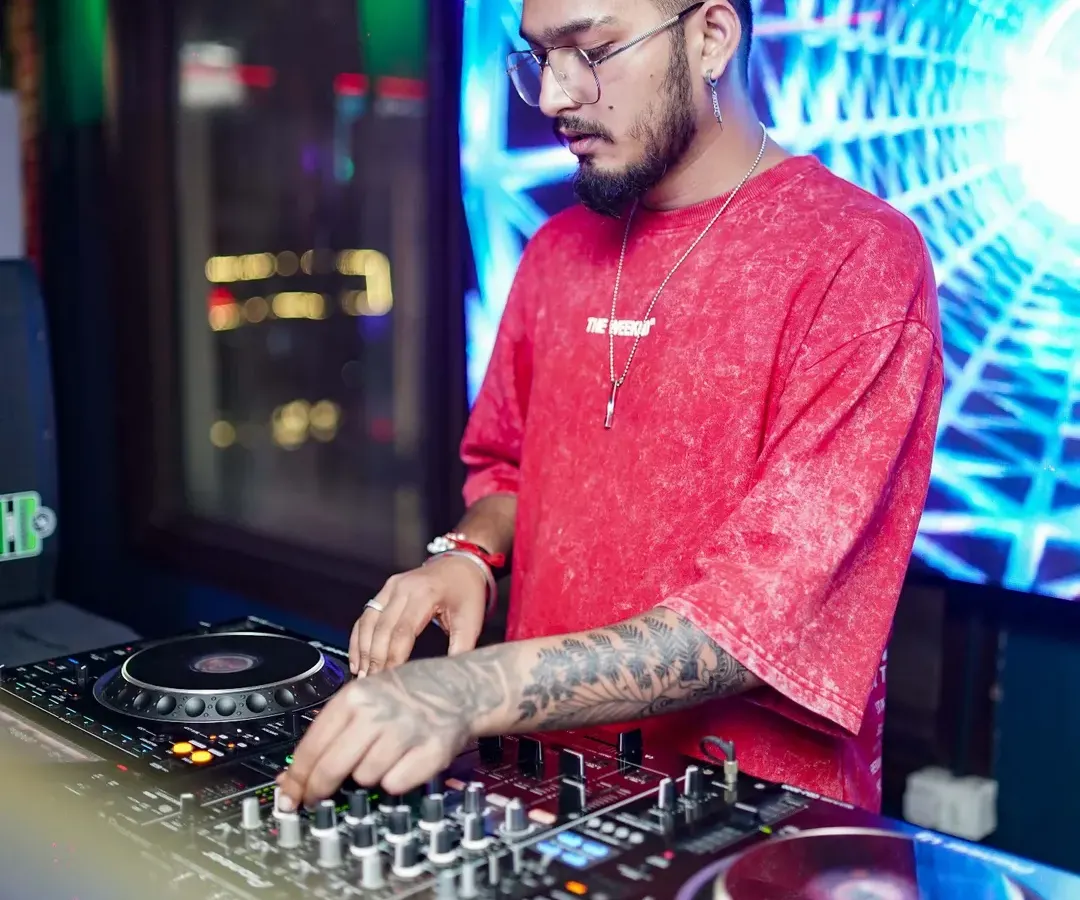 In the zone, crafting the perfect set. I use professional Pioneer DJ equipment to mix tracks seamlessly, reading the crowd to build energy and keep the dance floor alive. This is where the magic happens.