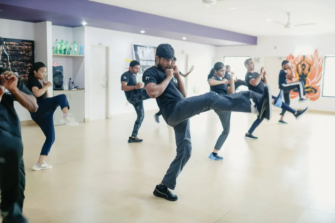 An instructor demonstrates a powerful defensive front kick during a Third Party Protection seminar in Mangalore. Our training emphasizes dynamic, full-body movements that are effective for creating distance and neutralizing a threat quickly.