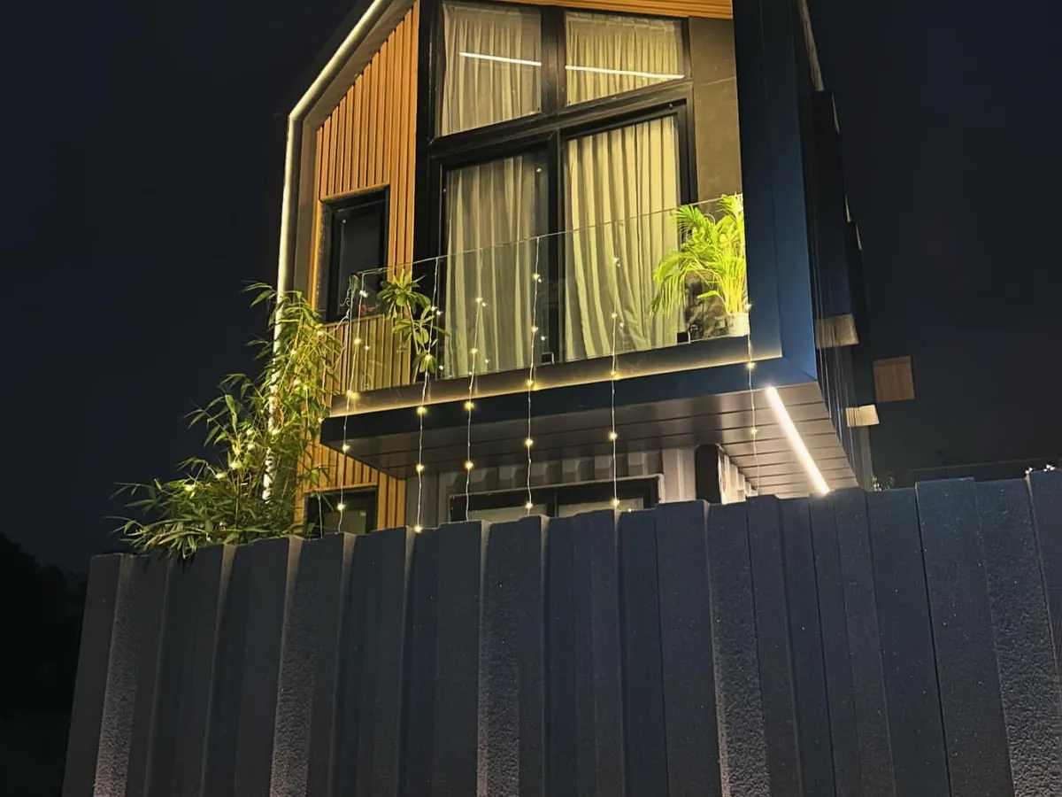 A look at a completed shipping container home at night. This project demonstrates how I transform industrial materials into warm, inviting, and sustainable living spaces with thoughtful lighting and design.