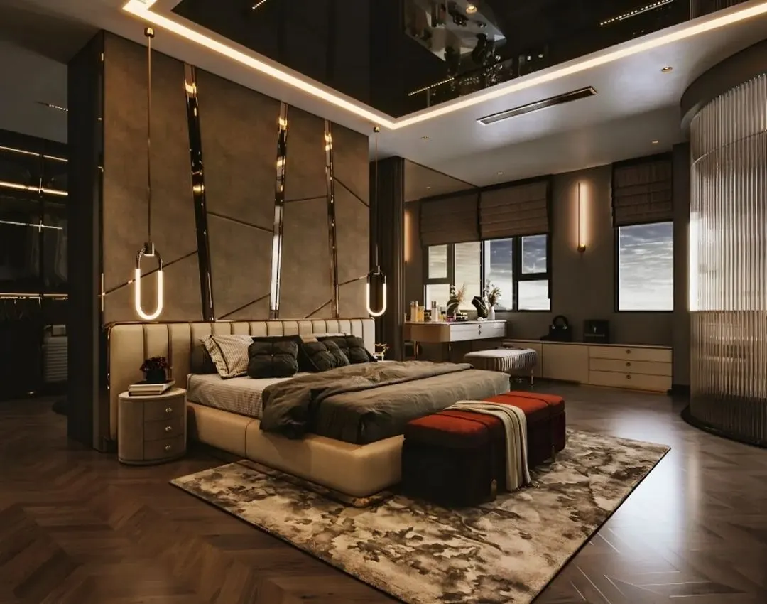 This is an example of a luxury master bedroom we designed, focusing on creating a lavish and restful retreat. The room features a custom upholstered headboard, dramatic accent lighting, and rich textures to create a truly opulent atmosphere with a dedicated seating and vanity area.