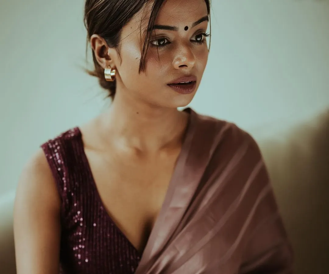 An intimate portrait focusing on the quiet, unspoken feelings. I used soft, natural light to highlight the delicate details of the satin saree and the model's expressive gaze, creating a photo that feels both classic and personal.