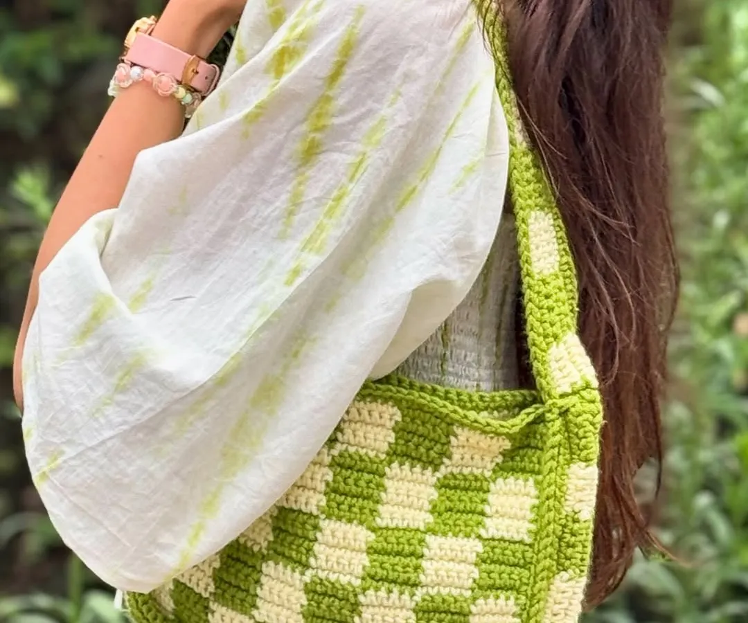 Our handmade checkered crochet shoulder bag, styled for a casual day out. This trendy and spacious bag adds a pop of color and a unique touch to any outfit.