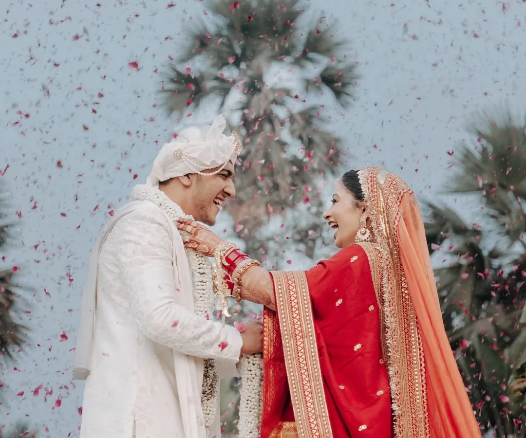 This is the kind of pure, unscripted joy we live to create. A candid varmala moment captured under a shower of rose petals, celebrating a love that's real and beautiful.