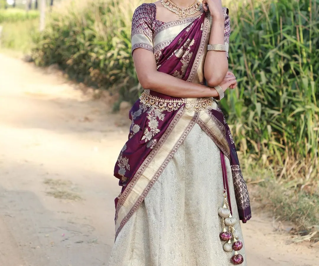 For a timeless South Indian look, I offer this beautiful Langa Voni, or half saree. The elegant combination of cream and deep purple silk is perfect for weddings and festive events.