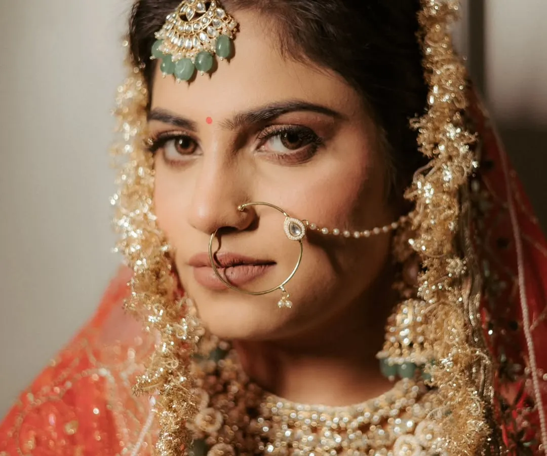A bride's gaze holds a universe of stories. This close-up portrait is all about capturing the quiet strength, anticipation, and timeless elegance of Ananya just moments before she walked down the aisle.