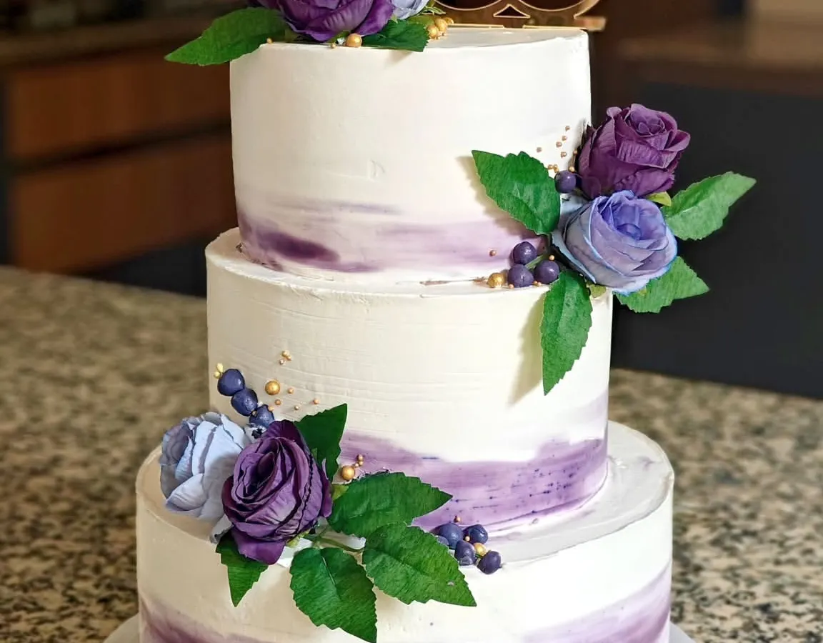 A classic three-tier wedding cake in a beautiful lavender watercolor effect, finished with delicate sugar flowers. I used whipped cream for a light, delicious taste, proving that large, structured cakes can be both stunning and free of heavy fondant.