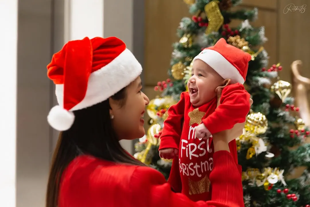 There is nothing more special than a baby's first Christmas. I love capturing the pure joy between a mother and her child, using the family's own festive tree as the perfect, personal backdrop for this unforgettable milestone.