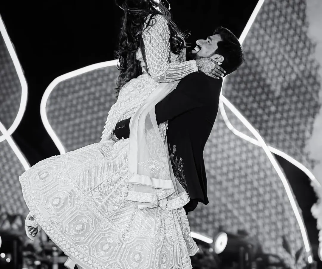 In the heart of the Sangeet, a moment of pure, weightless joy. I believe the best dance floor photos are unscripted, capturing the raw energy and connection between a couple.