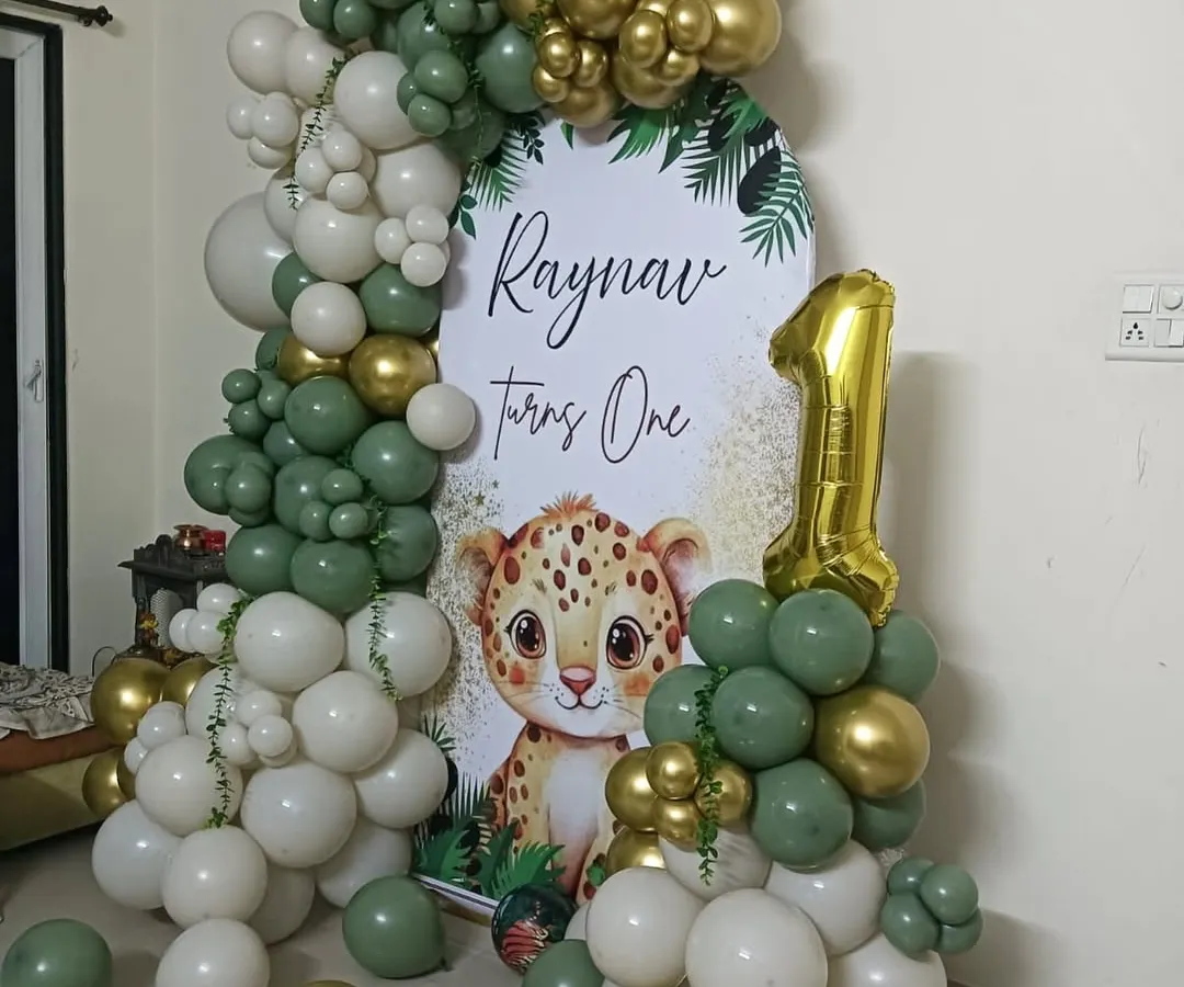 I really enjoy bringing popular themes to life, like this jungle safari first birthday for little Raynav. The combination of sage green, white, and gold balloons creates a modern and stylish look that parents love.