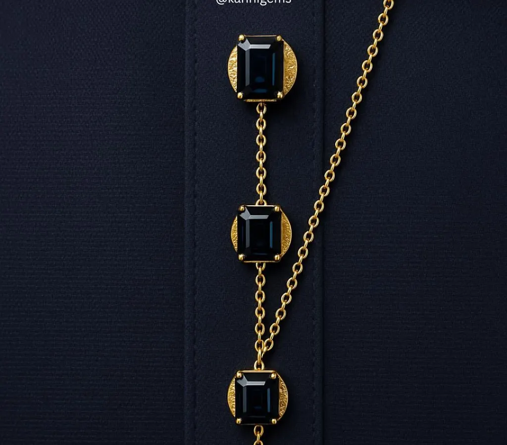 I transform functional details into statements of personal style. This custom button chain, featuring emerald-cut gemstones set in textured gold, is a bespoke creation for a formal shirt or kurta, showcasing how true luxury lies in the details.