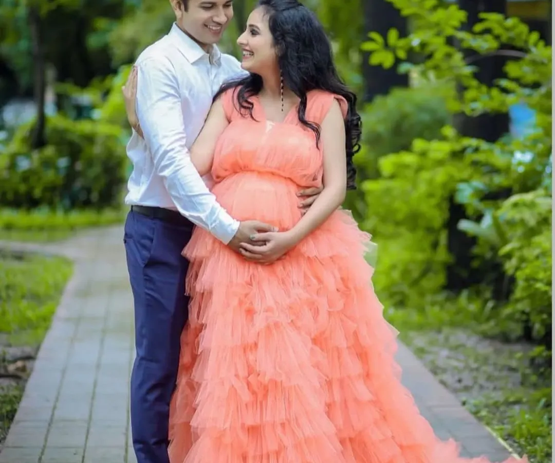 Celebrate your beautiful journey to motherhood with our peach ruffle maternity gown. Designed for comfort and style, its voluminous layers create a soft, dreamy silhouette perfect for capturing this special time. This rental gown ensures you look and feel like a queen during your maternity photoshoot.