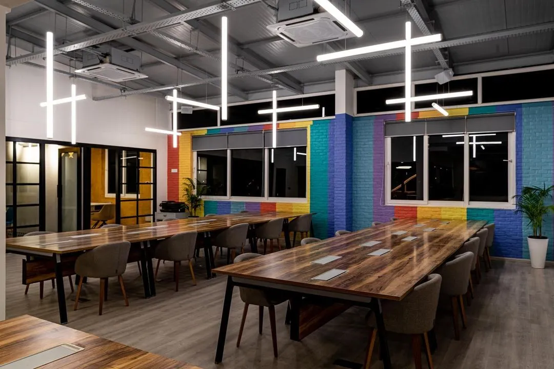In this double-height workspace, I wanted to do more than just illuminate the room. I designed a sculptural installation with LED tube lights arranged in a dynamic pattern. This approach provides uniform, comfortable light across the desks while also acting as a unique piece of art that defines the brand's creative energy.