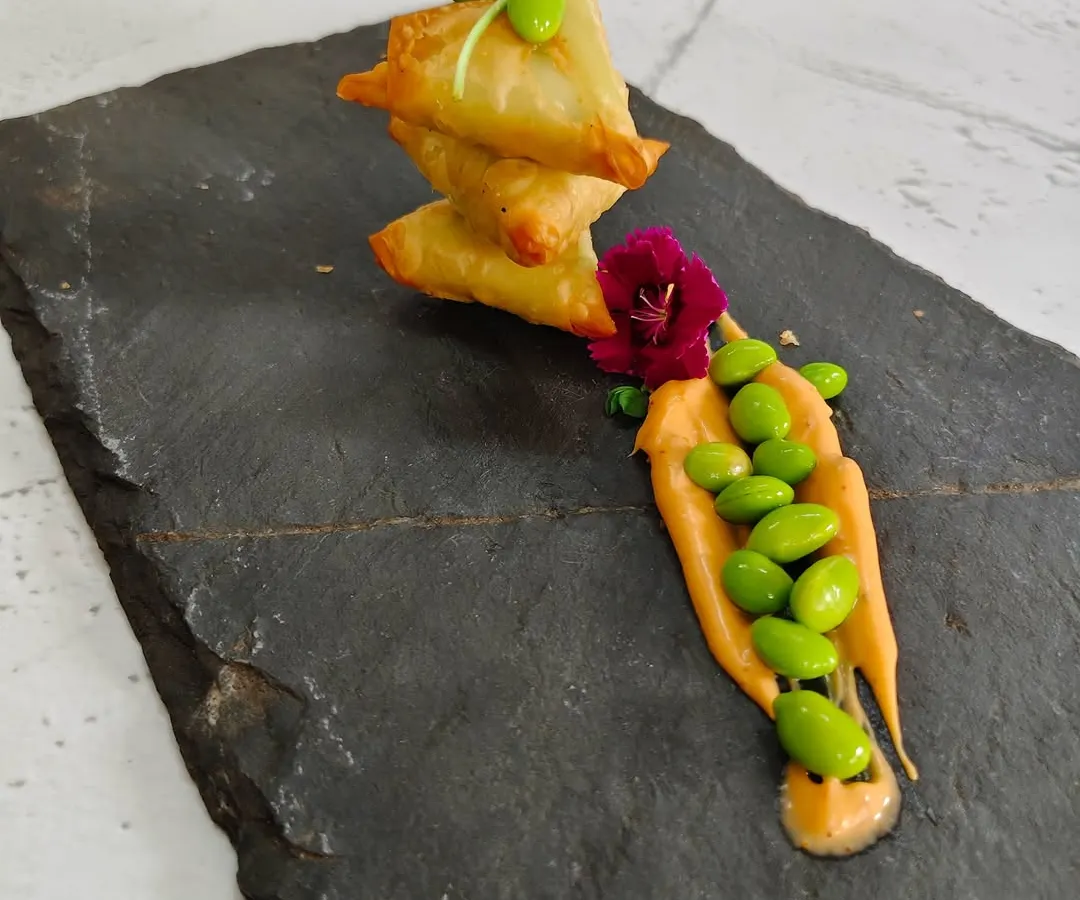 This is where tradition meets innovation. Our Edamame Truffle Samosas feature a golden, crispy pastry filled with creamy edamame and a hint of earthy truffle, creating a bite that is both familiar and surprisingly new.