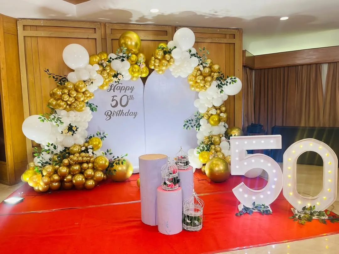 For this 50th milestone celebration, I designed a classic and elegant backdrop. The combination of gold and white balloons, paired with large marquee numbers, provides a perfect focal point for cake cutting and photos.