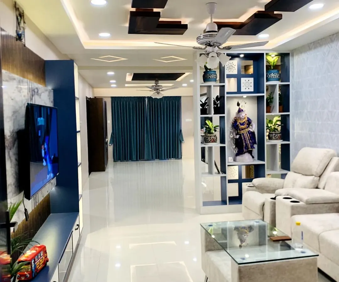 Here is a complete living and dining area I designed, focusing on a luxurious and open feel. Notice the layered false ceiling with wooden accents and integrated lighting, which creates zones and adds warmth, a key Vastu element for family spaces.