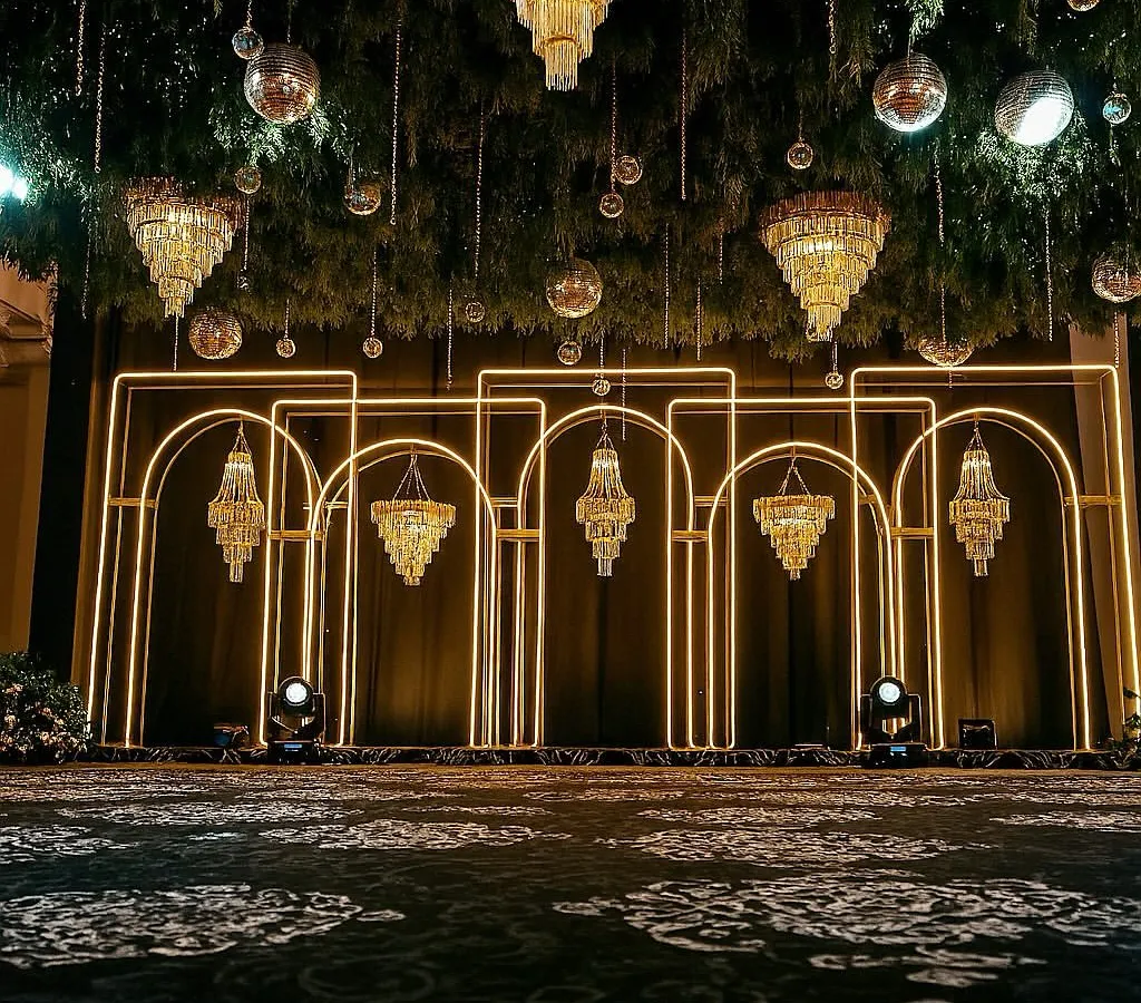 This is what we mean by 'Met Gala style'. For this Sangeet, we designed a modern, architectural backdrop with clean neon arches and dramatic crystal chandeliers, setting the stage for a high-energy night of glamour and celebration.