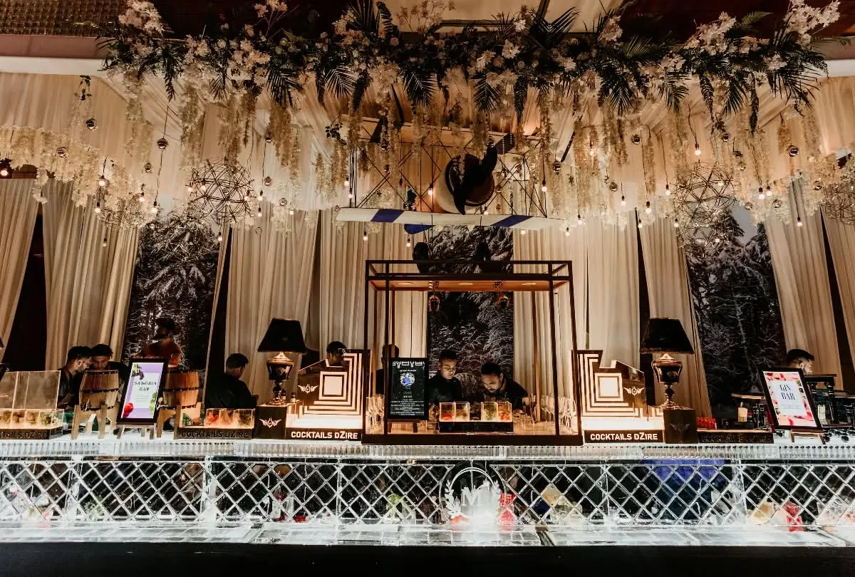 I designed this glamorous bar as the stunning centerpiece for a sangeet night. The intricate lattice work, overhead floral arrangements, and warm lighting created an unforgettable, high-end cocktail experience.