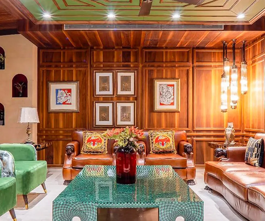 I believe a living room should have soul. For this space, I used warm wood paneling, a custom-designed green malachite table, and rich leather sofas to create a classic, inviting atmosphere that feels both grand and comfortable.
