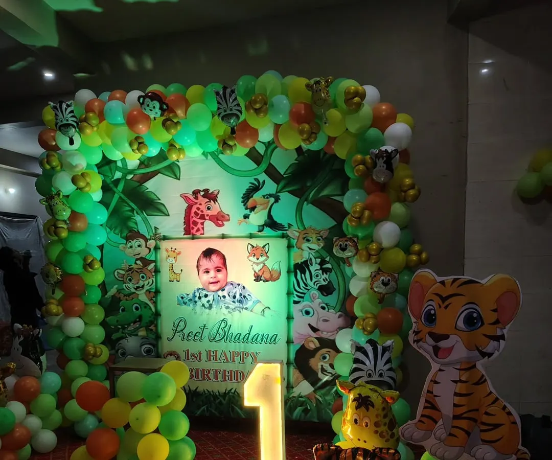 For kids' parties, themes are everything. Here is a jungle theme I did for a first birthday, complete with a personalized backdrop, animal cutouts, a full balloon arch, and a light-up number '1'.